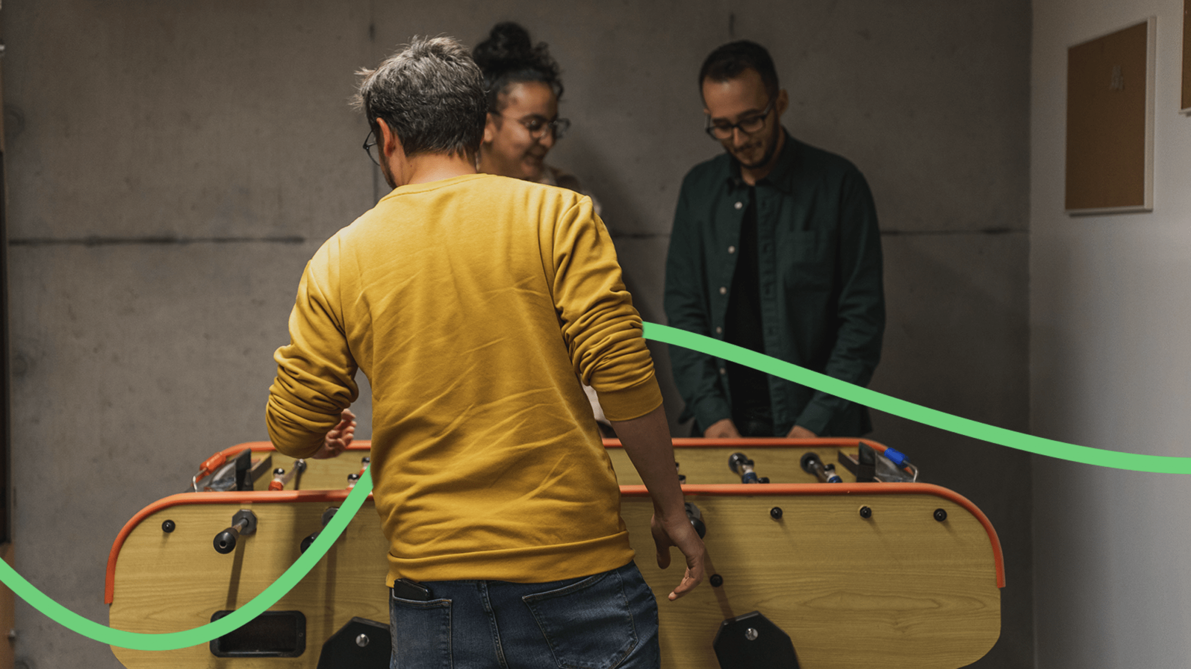 Picture of people from At home playing table soccer.